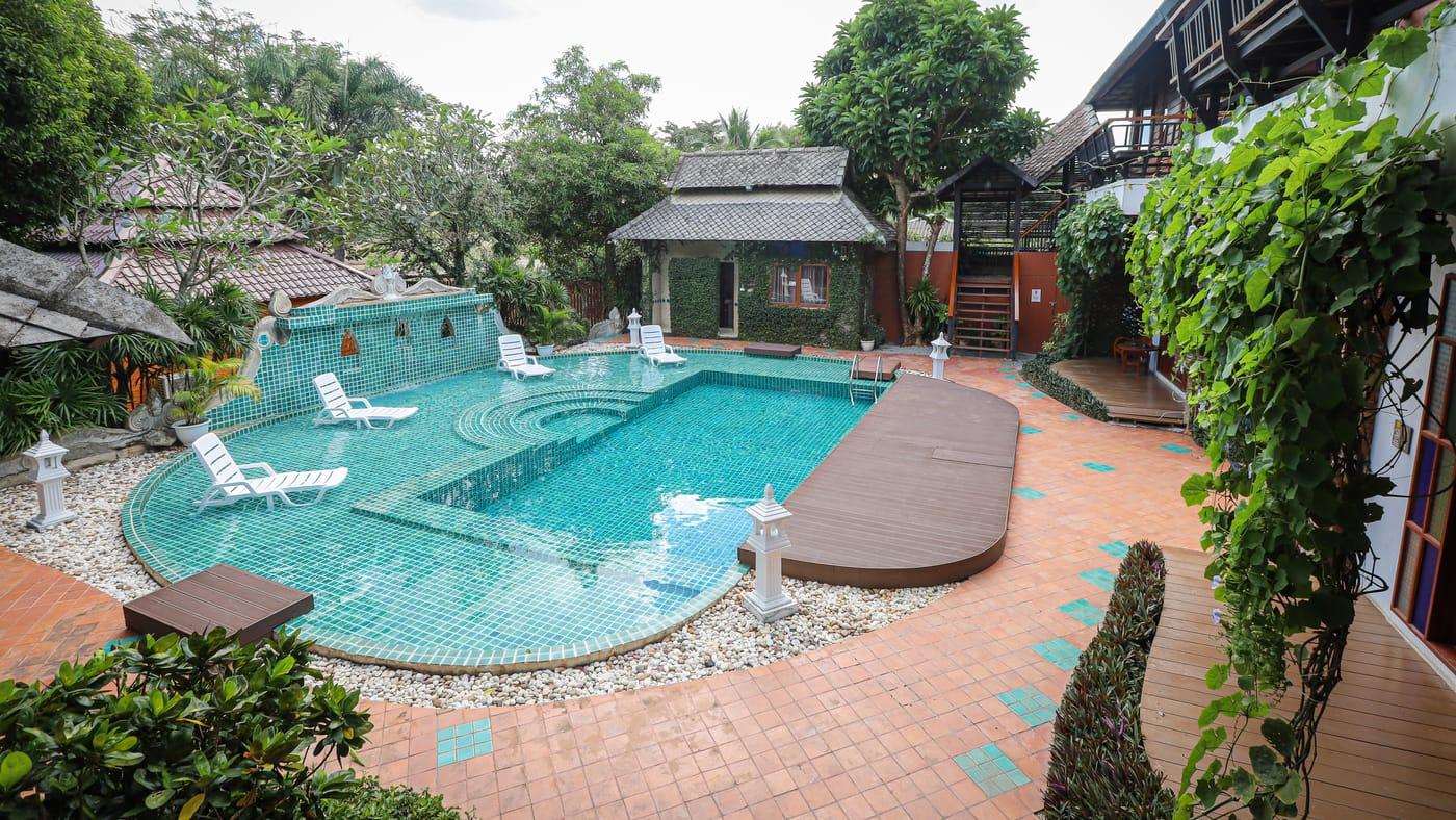 Pool terrace, timber sala and Lanna-style buildings in the grounds of Jintara Rehab in Chiang Mai Thailand