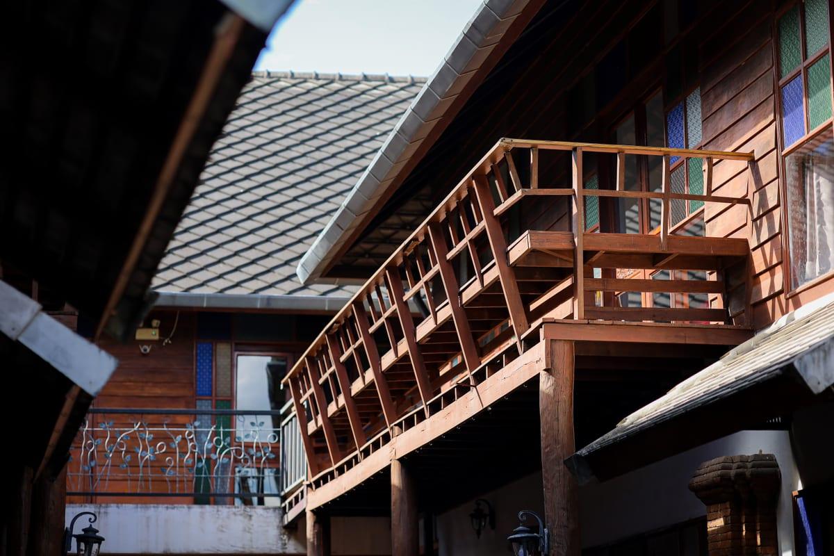 Teak buildings and stained-glass walkways at Jintara Rehab in Chiang Mai, the Thailand facility Australian clients travel to