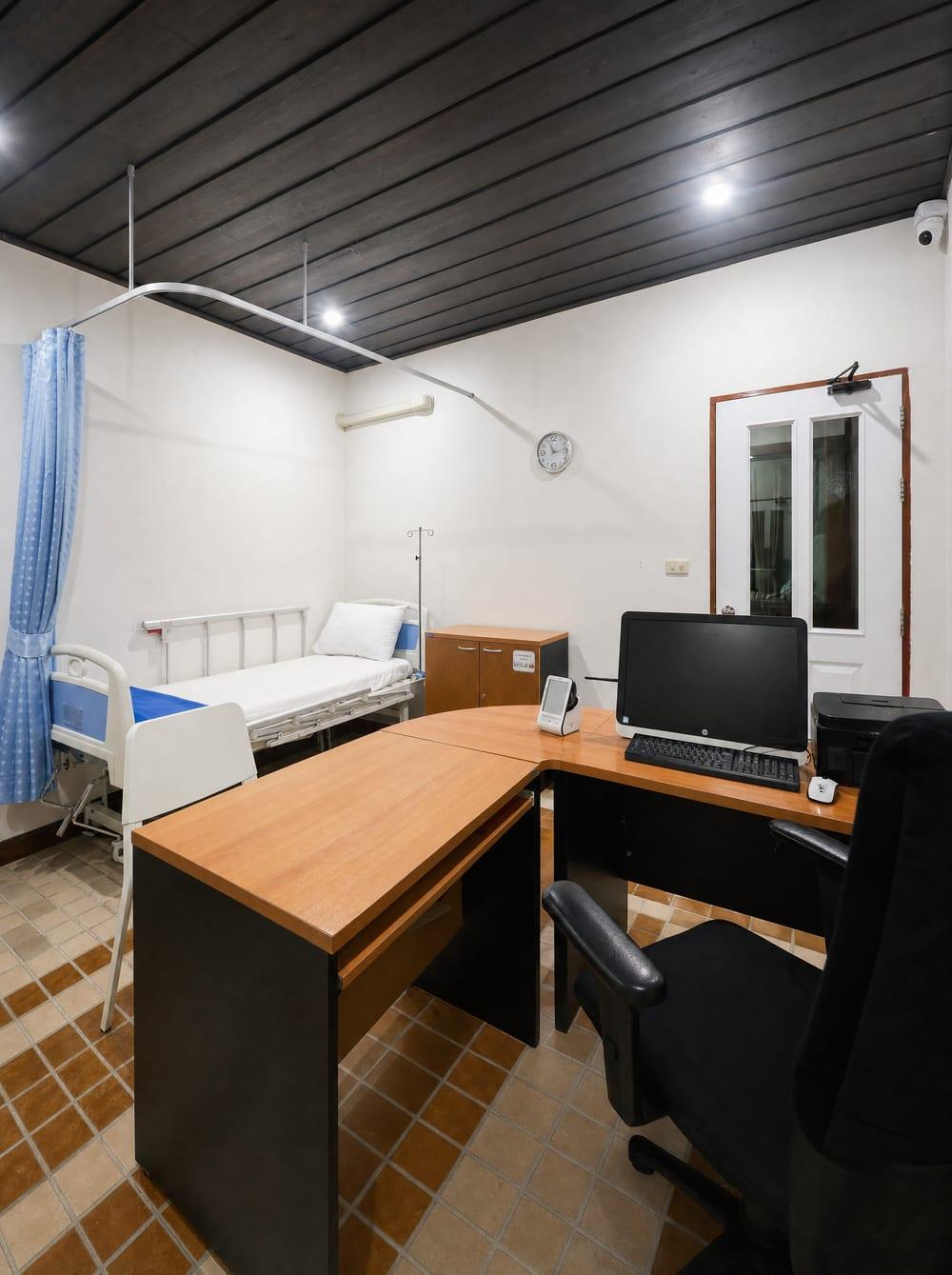 Clinical treatment room with hospital bed, desk and monitoring station at Jintara Rehab Chiang Mai