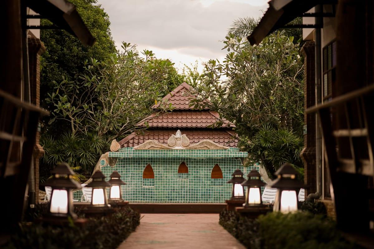 Daytime walkway with lanterns at Jintara Rehab Thailand leading toward the admissions process for benzo detox
