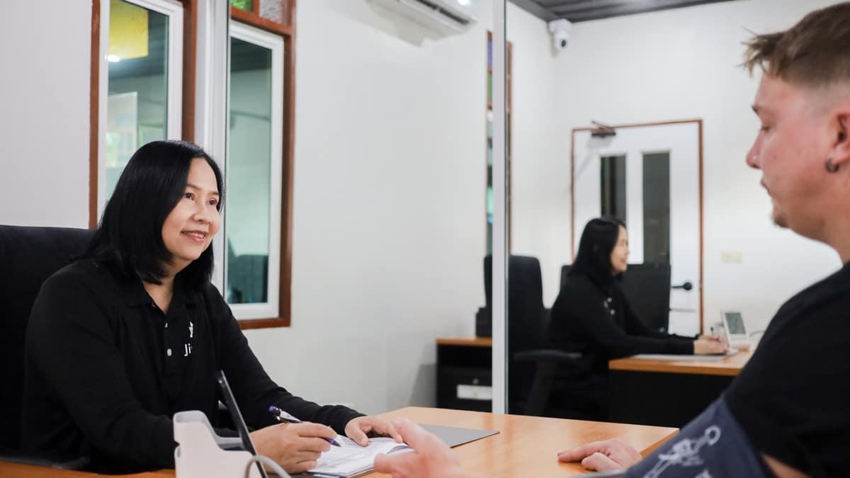 Clinical consultation at Jintara Rehab Chiang Mai with nurse and client at intake desk