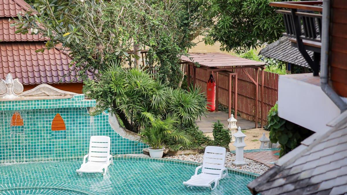 Elevated view over the mosaic pool terrace and garden at a Chiang Mai rehab