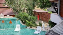 Elevated view over the mosaic pool terrace and garden at a Chiang Mai rehab