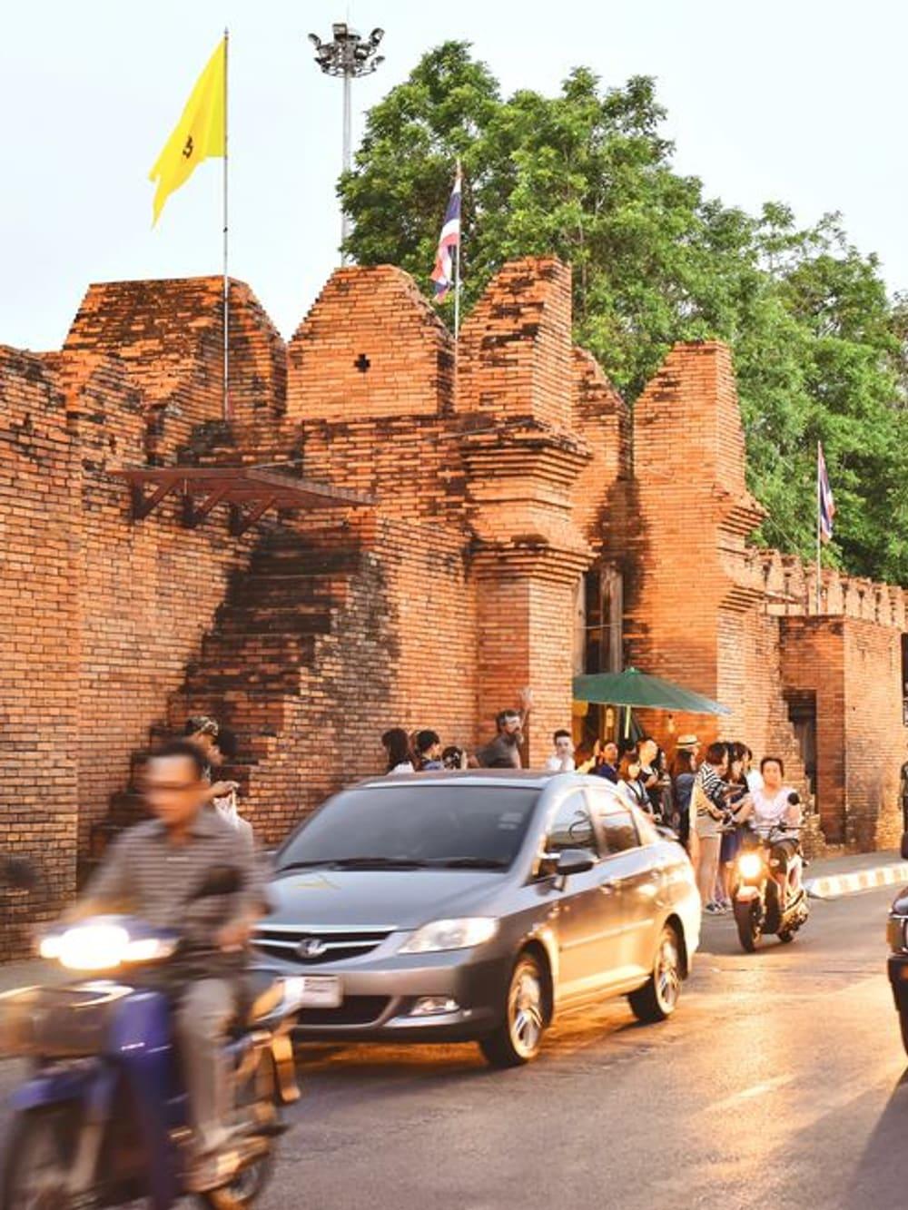 The historic Tha Phae Gate and old-city street life in Chiang Mai, the functioning city that surrounds Jintara Rehab