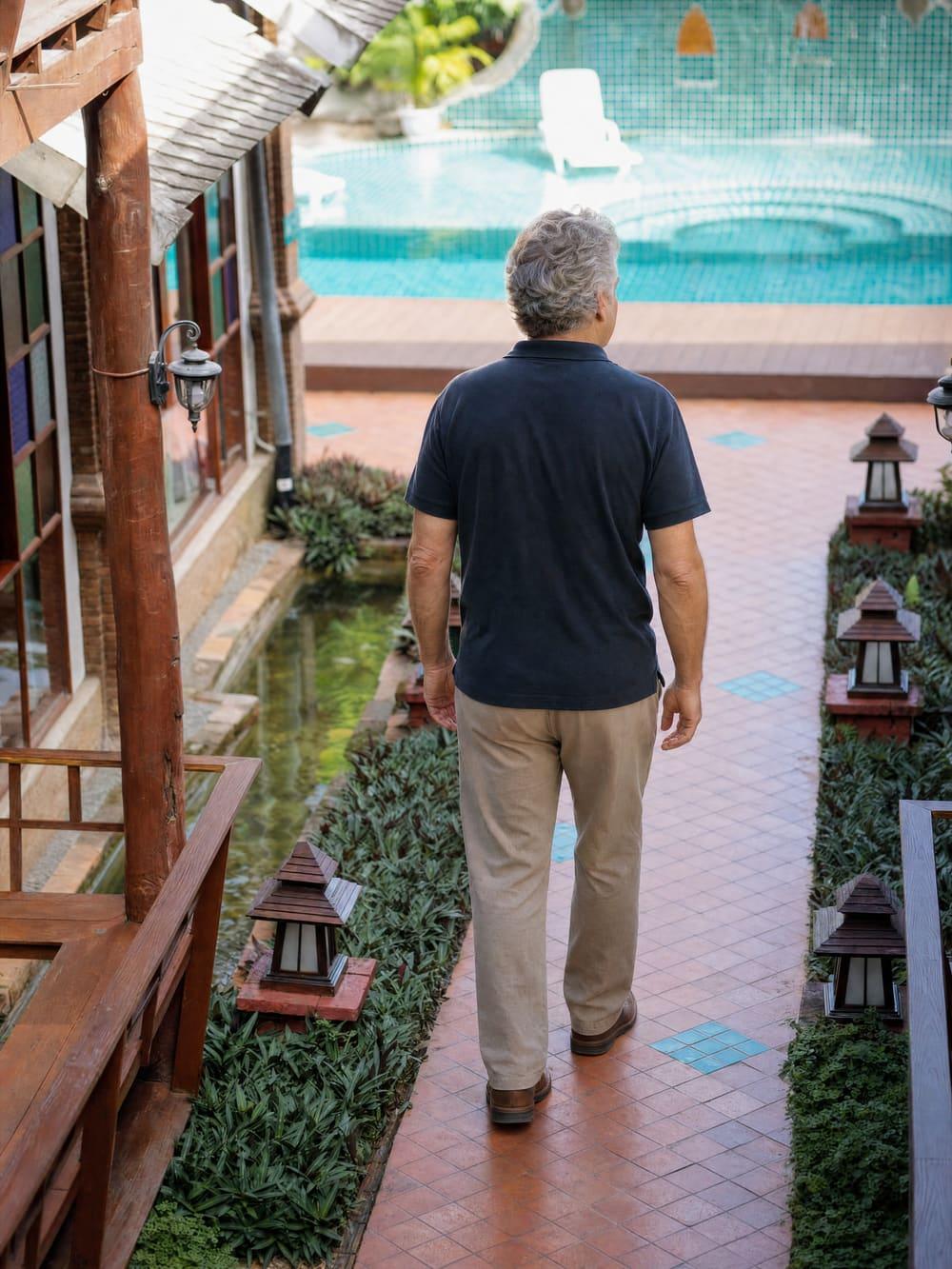 A client walking alone down a private garden path at Jintara Rehab in Chiang Mai, unobserved