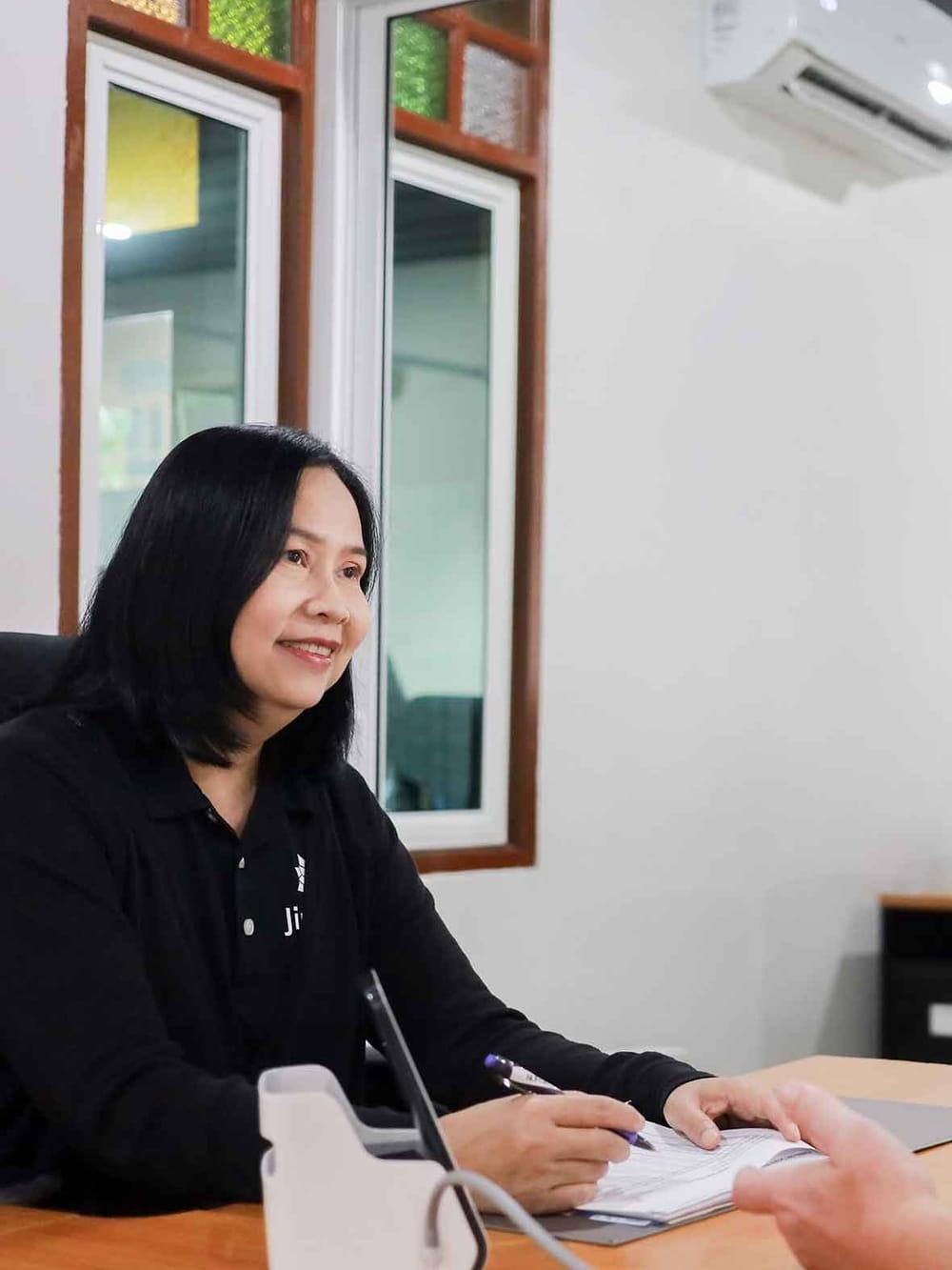 A Jintara clinician recording observations during a medical assessment at the facility in Chiang Mai
