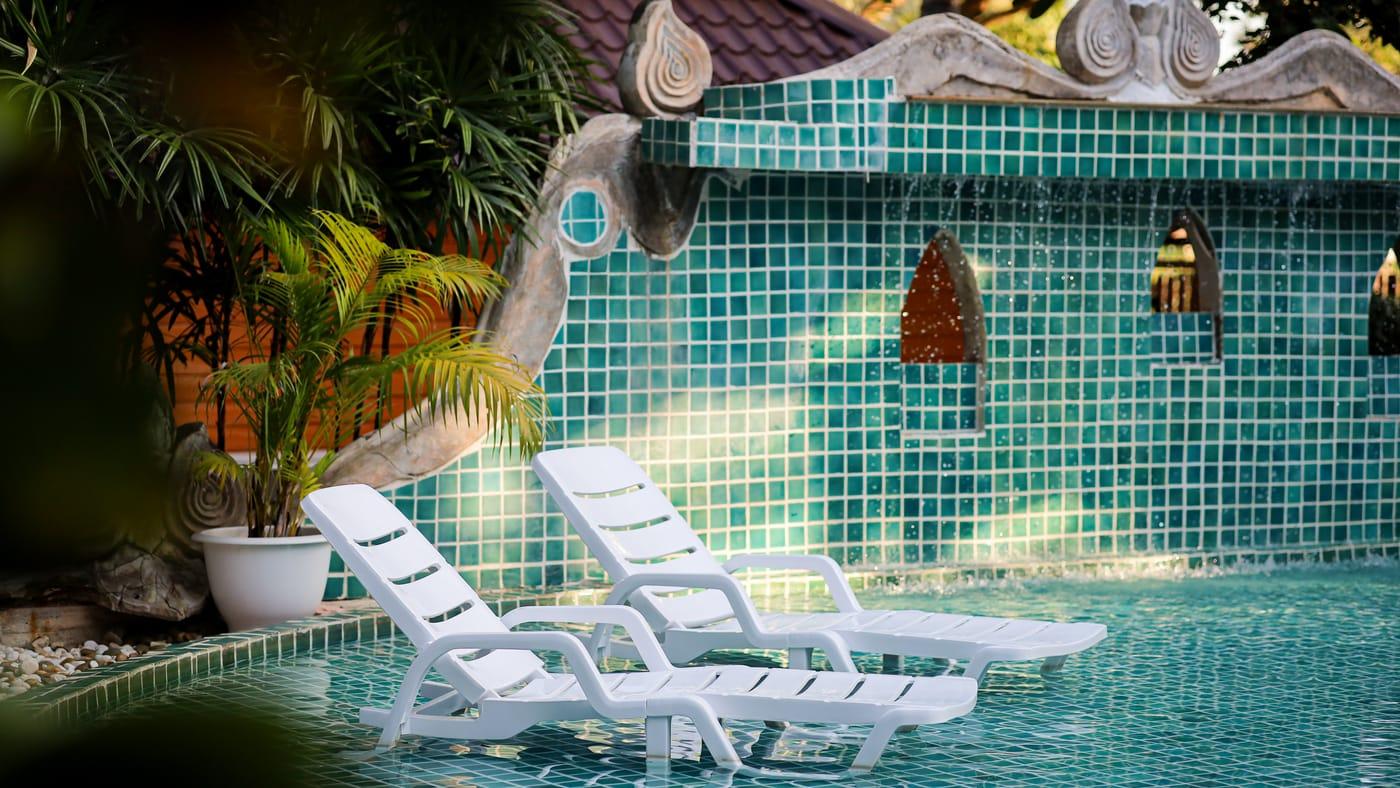 The mosaic pool and tropical garden at Jintara Rehab Chiang Mai, the calm setting for cannabis withdrawal recovery