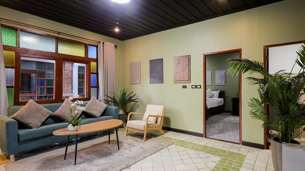 A calm private suite lounge with a doorway to the bedroom at Jintara Rehab Chiang Mai, where cannabis clients settle through early withdrawal