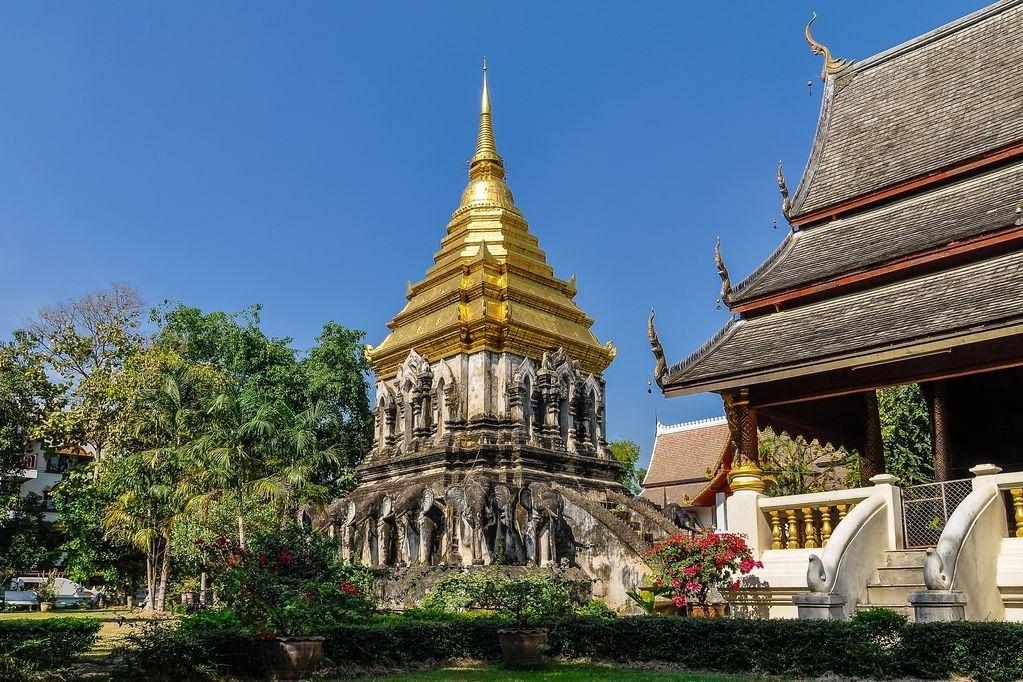 The gilded chedi and teak viharn of Wat Chiang Man in the old city of Chiang Mai on a clear morning