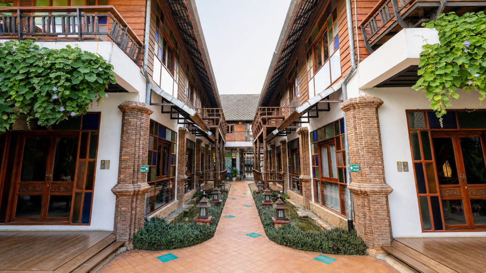 Jintara Rehab compound walkway at evening in Chiang Mai Thailand, where cocaine and alcohol treatment runs on two parallel clinical tracks