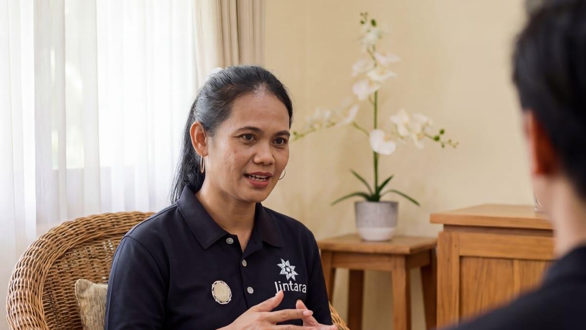 Clinician in a wicker chair speaking with a client during a one to one session