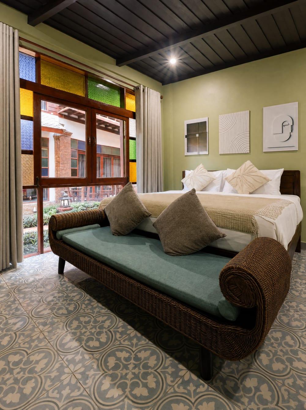 Private bedroom with stained glass windows at Jintara Rehab Chiang Mai, representing the personal space and privacy available to each client