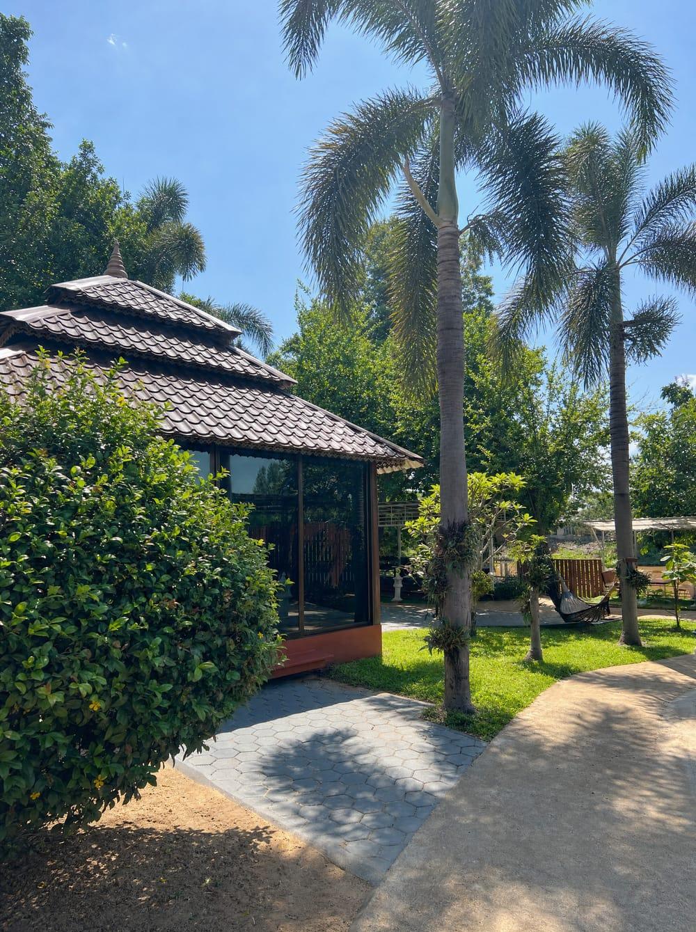 Glass therapy pavilion surrounded by tropical garden at Jintara Rehab Chiang Mai recovery centre