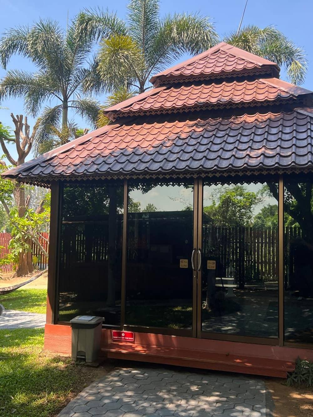 Traditional Lanna-style sala pavilion surrounded by tropical palms at Jintara Rehab Chiang Mai