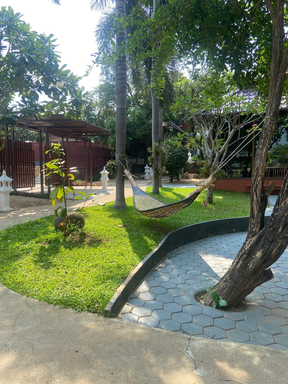 A hammock slung between two trees on the lawn at Jintara Rehab in Chiang Mai, photographed by a Google reviewer