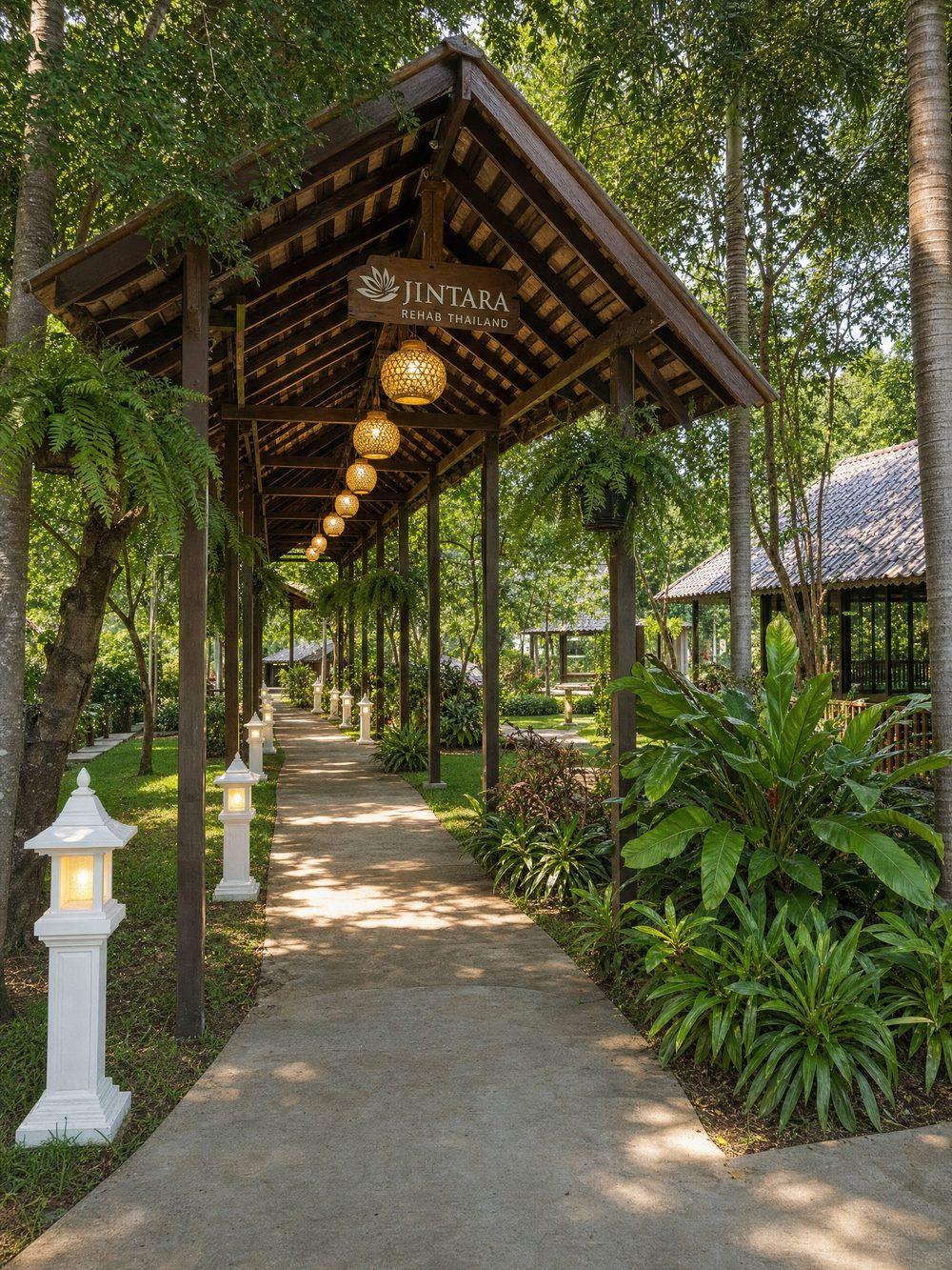 Garden pathway with hanging lanterns at Jintara Rehab in Chiang Mai, Thailand