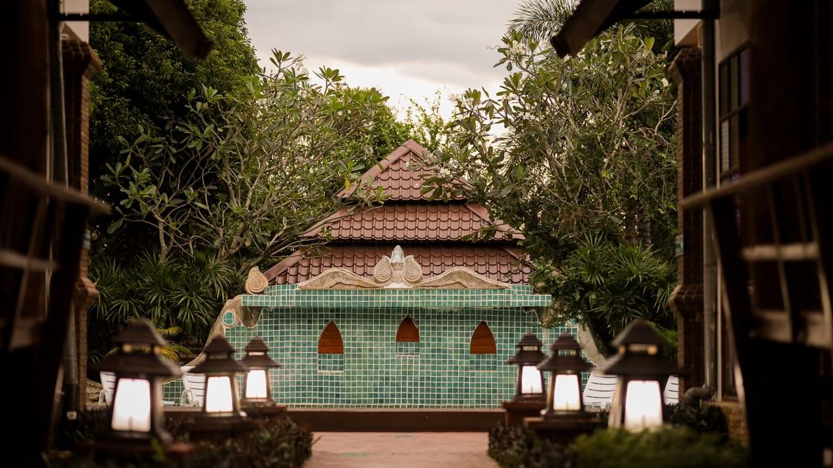Green-tiled Lanna pavilion and lantern path at Jintara rehab Chiang Mai