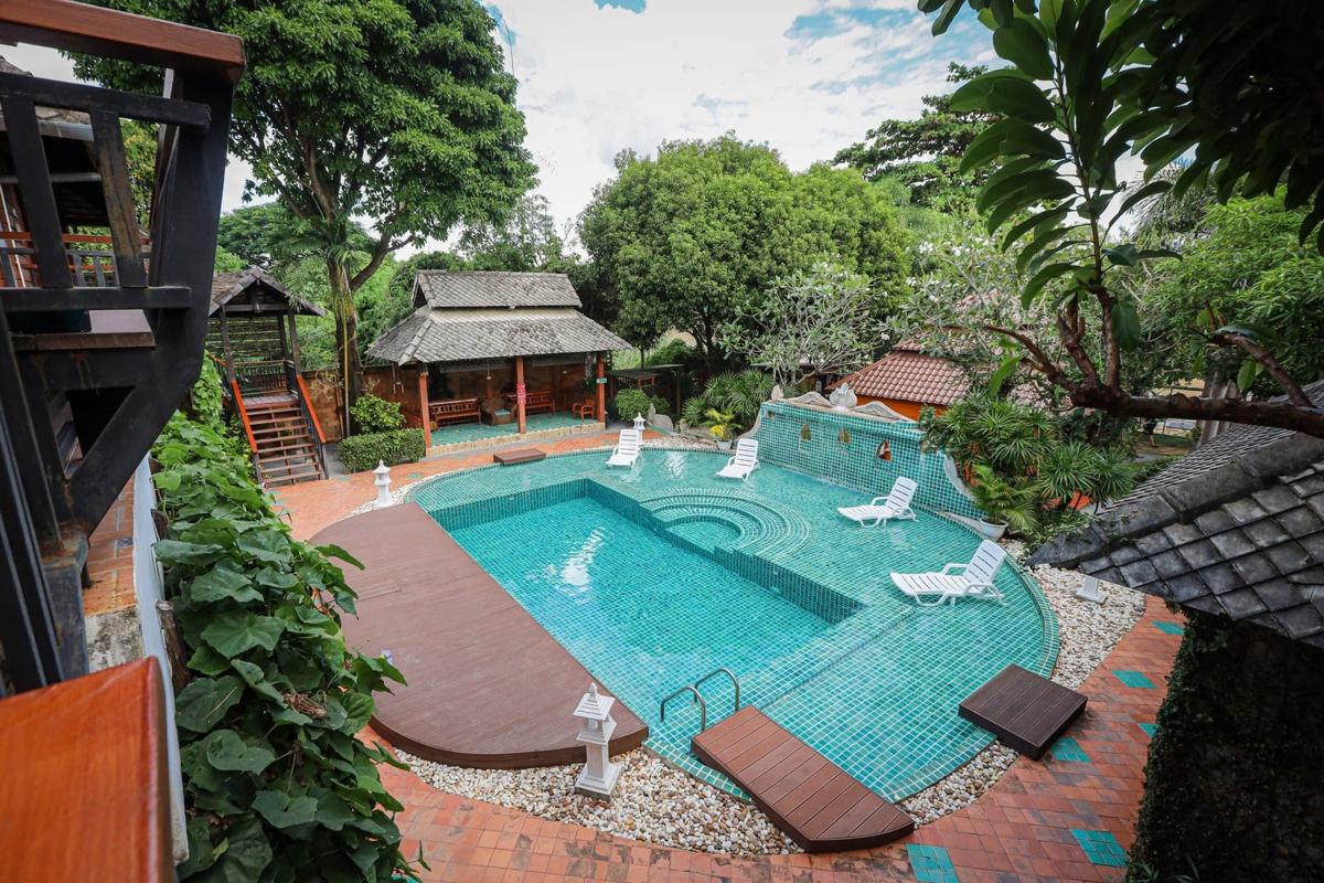 Jintara Rehab pool courtyard viewed from above in bright daytime, Chiang Mai Thailand addiction treatment facility