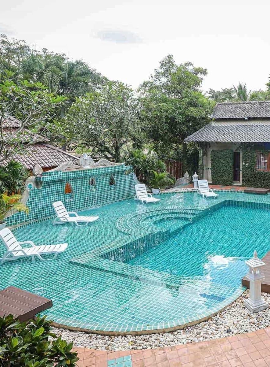 Swimming pool and Lanna buildings at Jintara Rehab during medical detox recovery