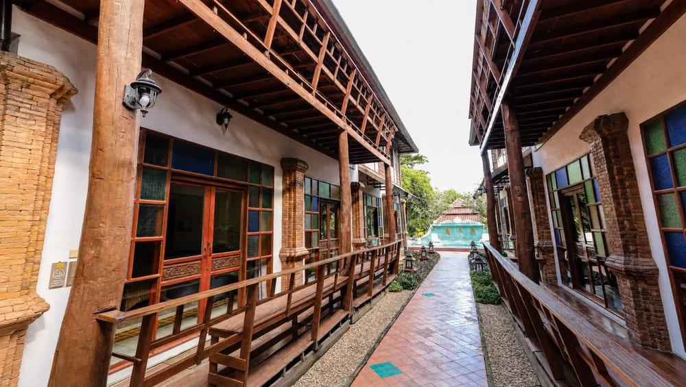 Covered walkway with lanterns leading through the grounds at Jintara Rehab in Chiang Mai