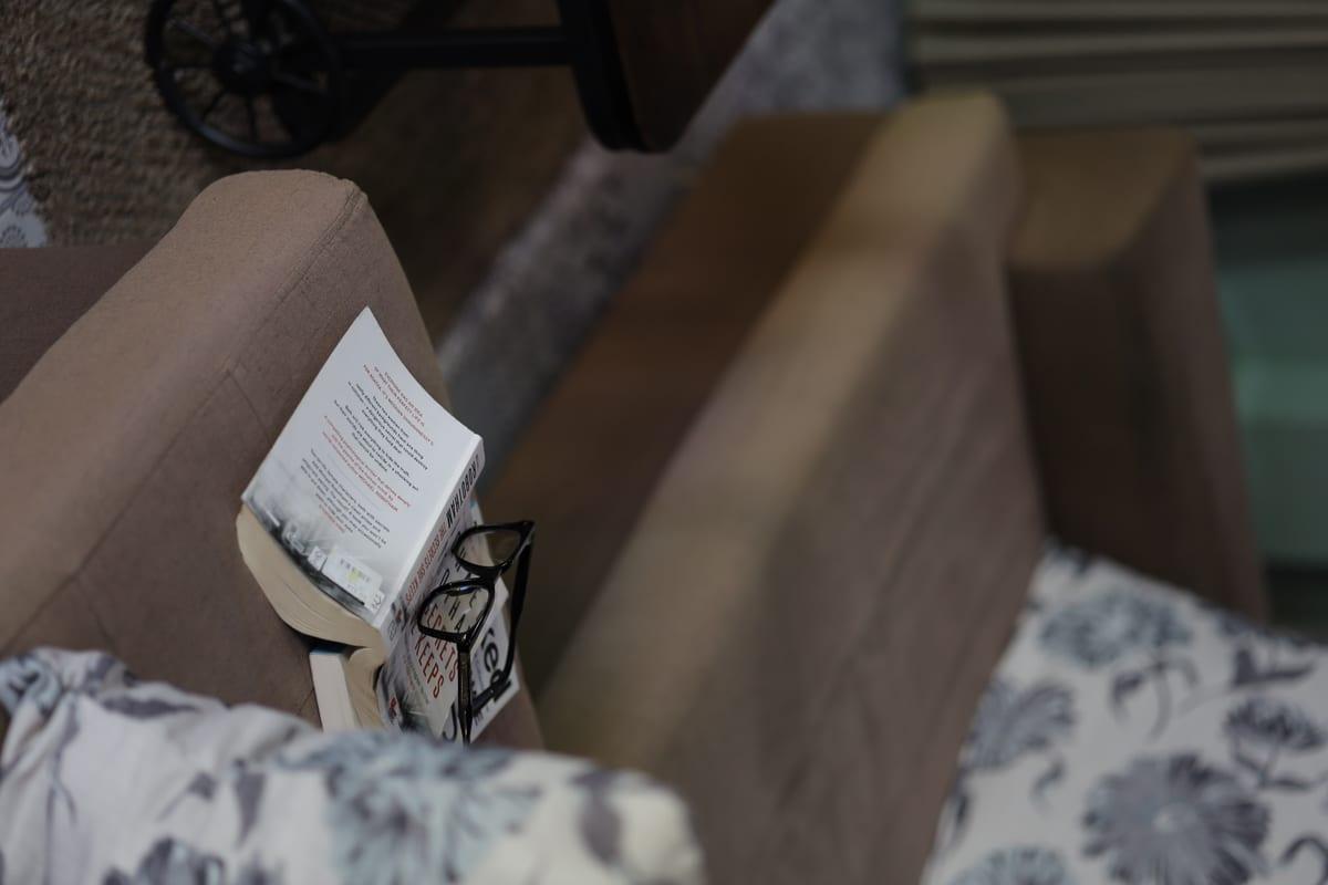 Book and reading glasses resting on a sofa at Jintara Rehab addiction treatment Chiang Mai Thailand