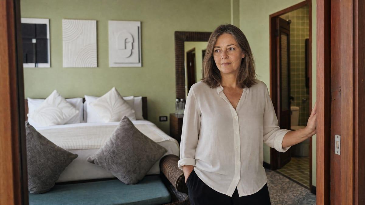 Woman in her fifties standing in the doorway of a private guest room at Jintara Rehab Chiang Mai Thailand