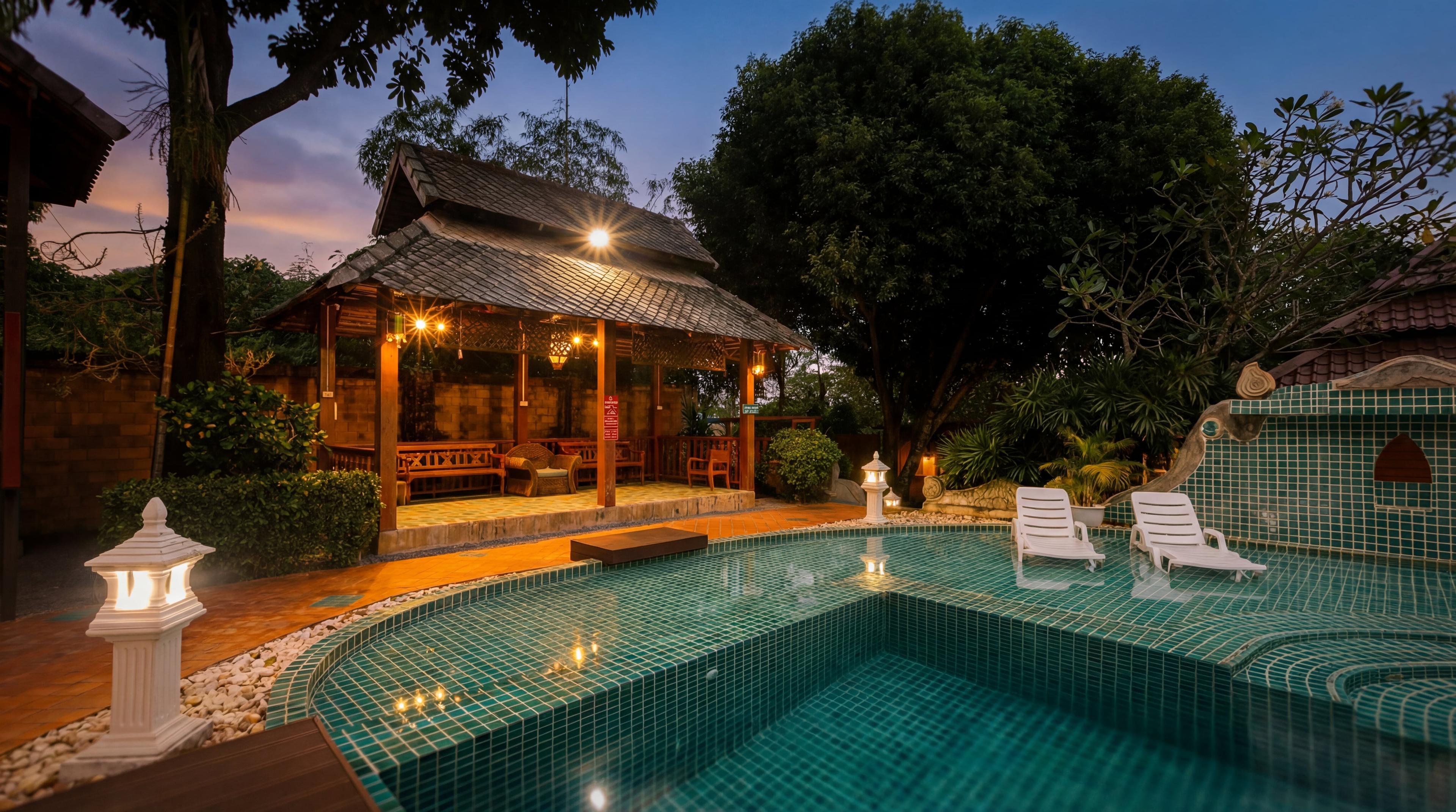 Pool and pavilion at Jintara Rehab during evening golden hour in Chiang Mai