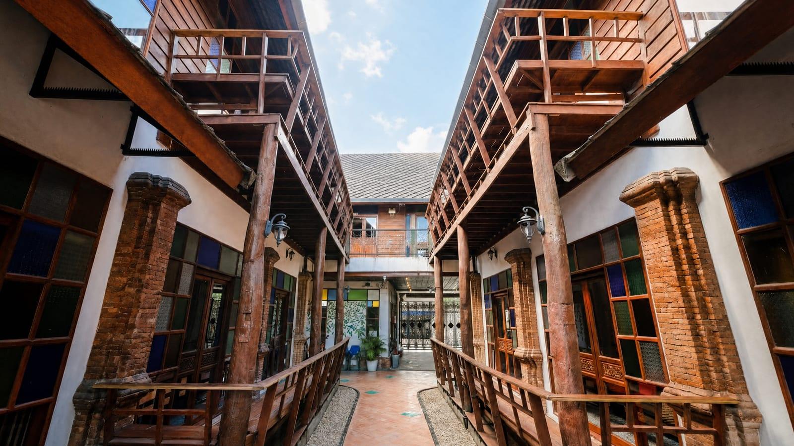 Teak-columned compound courtyard at Jintara Rehab Chiang Mai where psychiatric assessment starts on day one