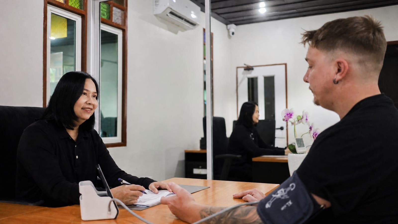 Clinical intake consultation between a nurse and client in the Jintara assessment room Chiang Mai