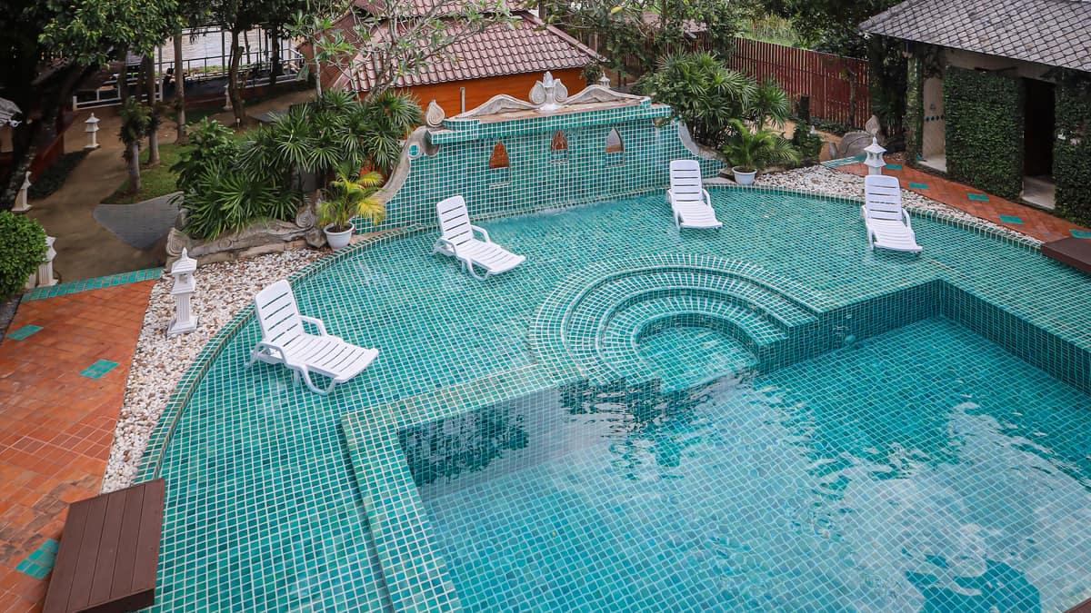 The mosaic pool and garden grounds at Jintara Rehab Chiang Mai where cannabis clients settle through the early weeks