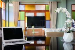 Jintara Rehab lounge with stained glass windows and laptop, Chiang Mai Thailand