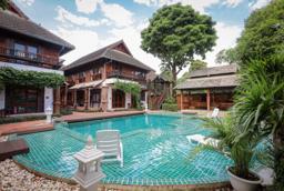 Turquoise pool and Lanna teak buildings at Jintara Rehab addiction treatment facility Chiang Mai