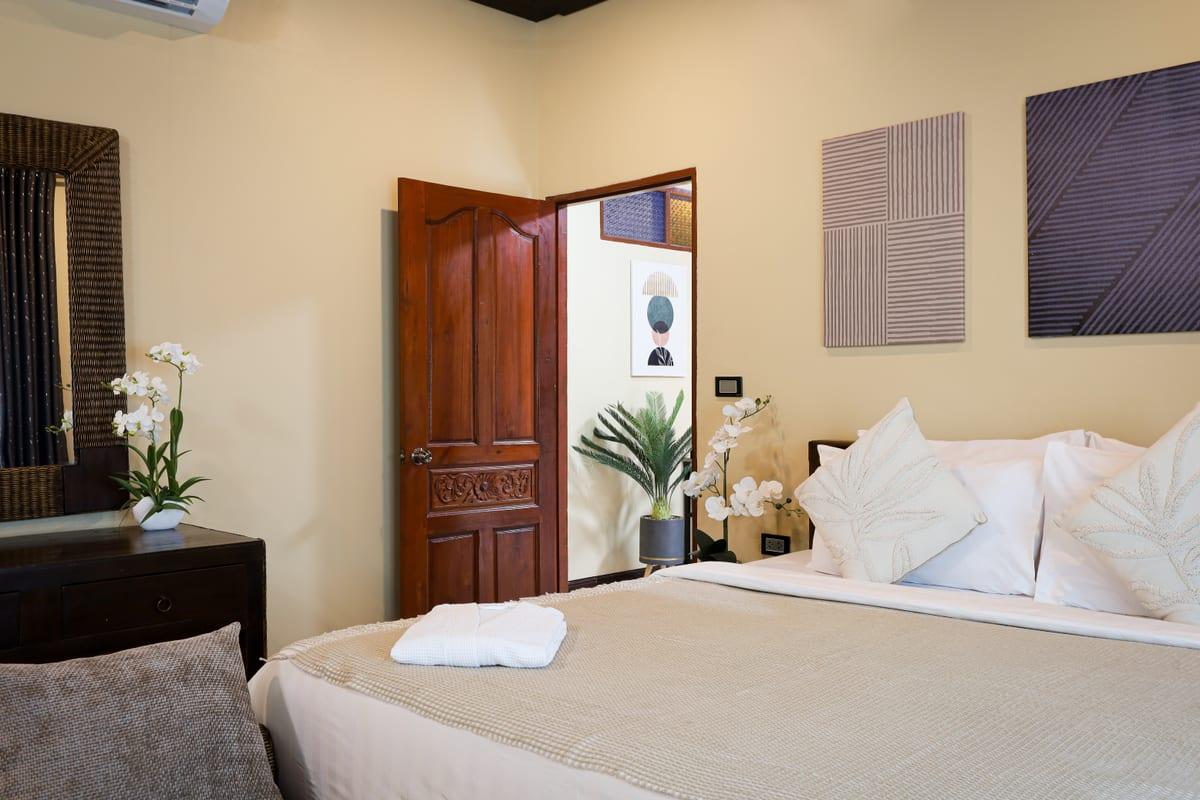 Private bedroom with white linens and orchid flowers at Jintara Rehab Chiang Mai private facility
