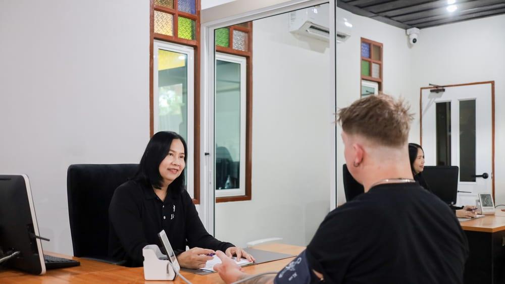 Jintara nurse conducting blood pressure monitoring with a client in the medical consultation room during detox assessment