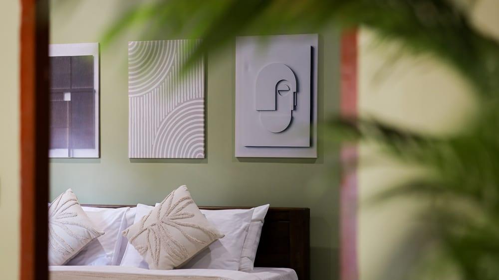 Private bedroom at Jintara Rehab Chiang Mai with green sage walls and crisp white linen, showing the calm residential setting where sleep recovery begins
