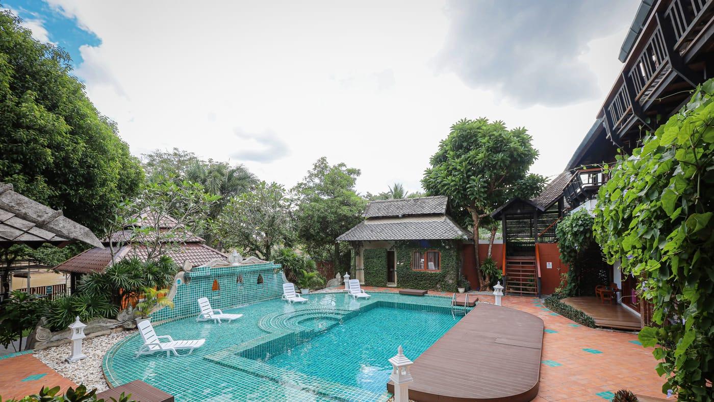 Swimming pool and teak buildings at Jintara Rehab in Chiang Mai