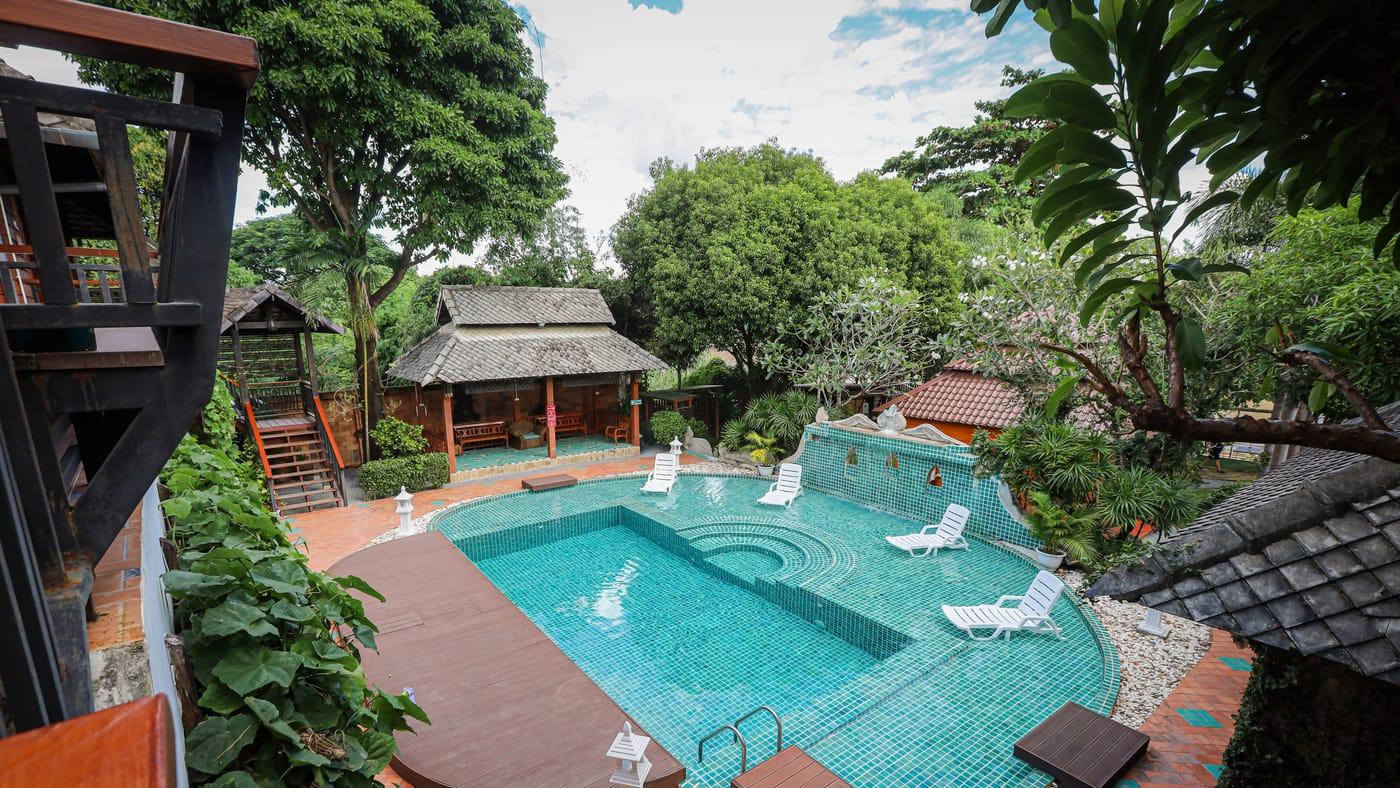 The pool, timber deck and garden sala in daylight at Jintara Rehab in Chiang Mai