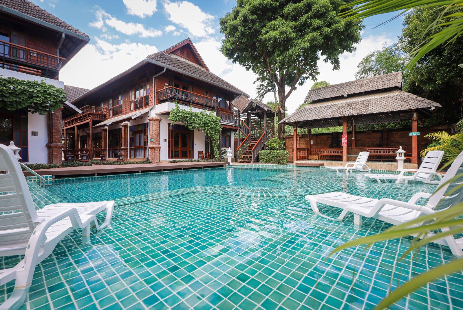 The pool courtyard and teak residential buildings at Jintara Rehab in Chiang Mai