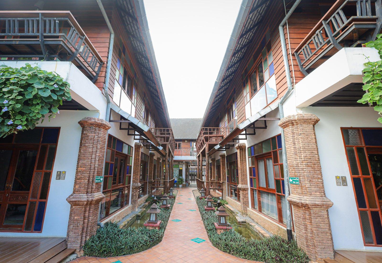 A brick walkway between timber residential buildings at Jintara Rehab