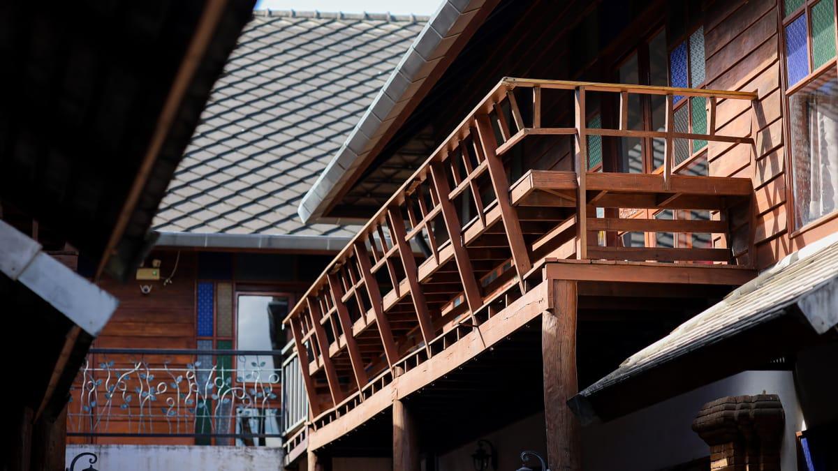 Teak buildings with wooden balconies at Jintara Rehab in Chiang Mai