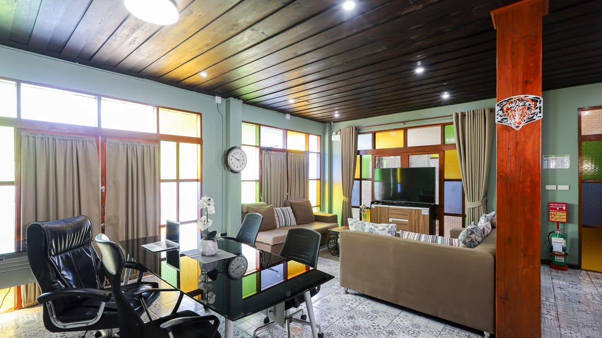 The medical room with a consultation desk, sofas and stained-glass windows at Jintara Rehab in Chiang Mai