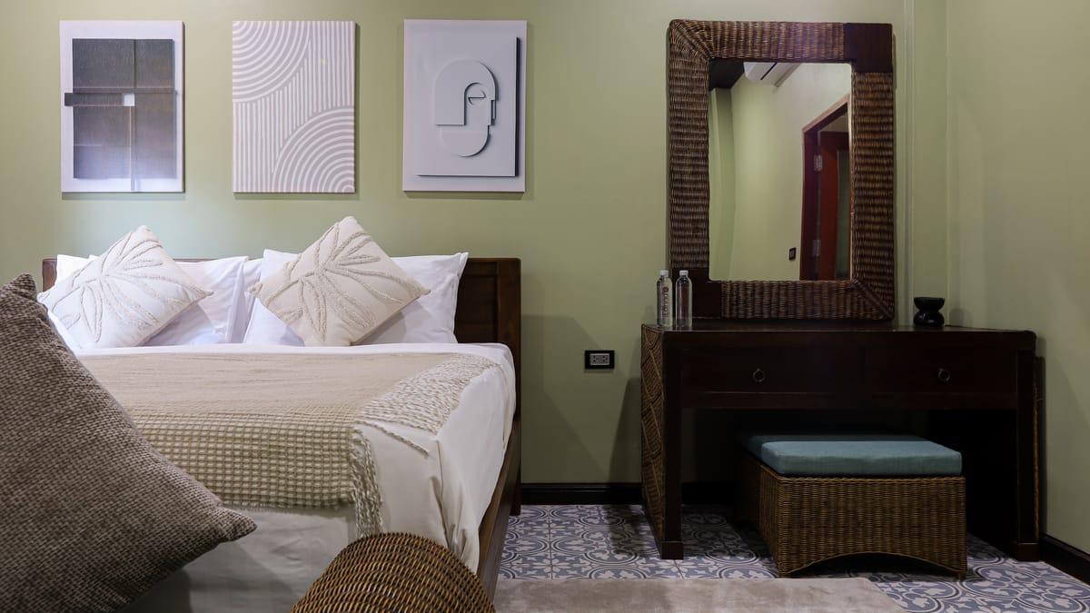 Bedroom with a double bed, dressing table and mirror at Jintara Rehab in Chiang Mai
