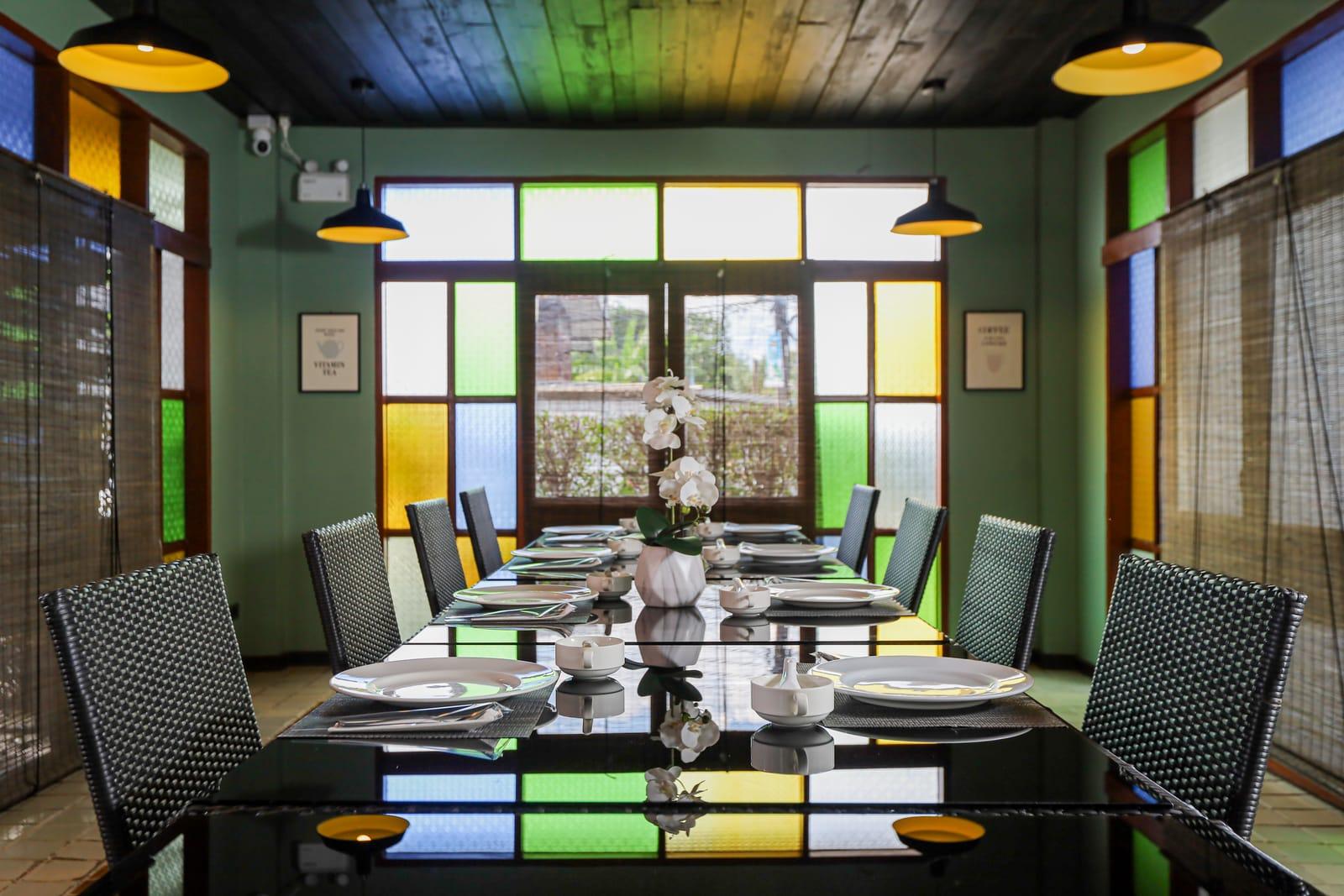 The dining room with stained-glass windows at Jintara Rehab in Chiang Mai