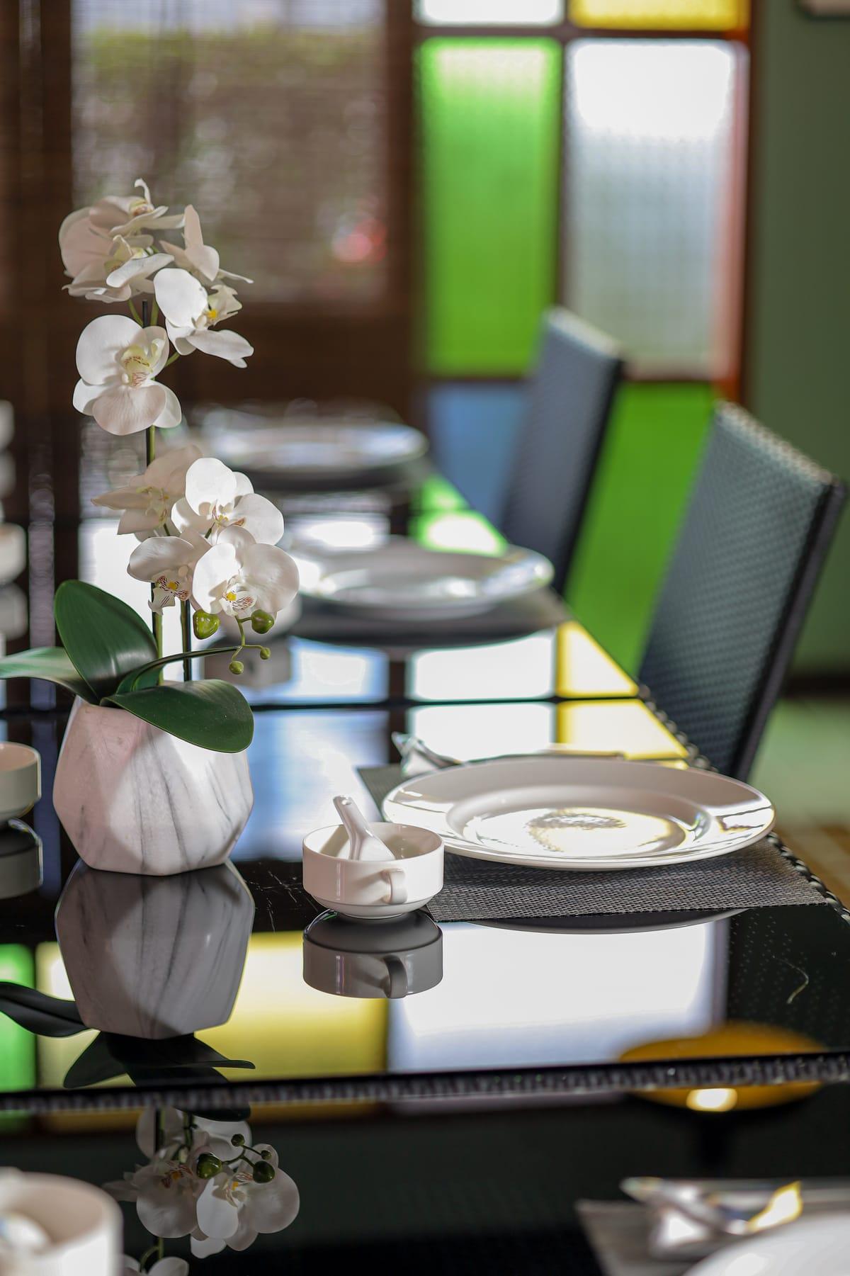 A white orchid on a dining table at Jintara Rehab in Chiang Mai