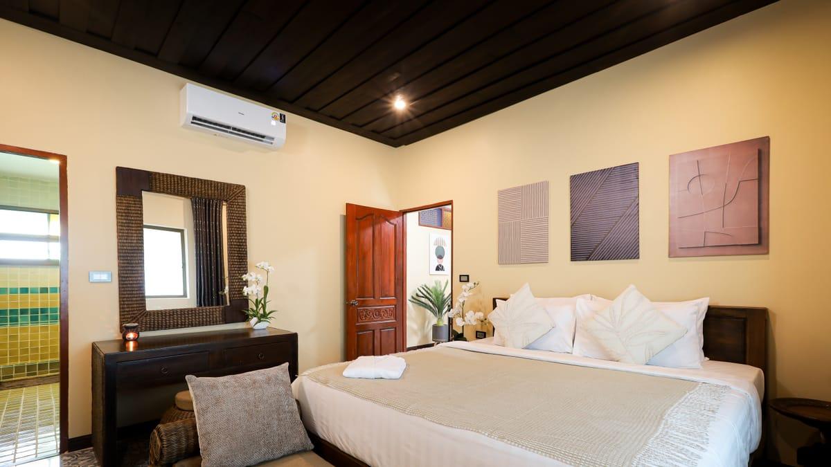 Bedroom with a double bed and a mirror at Jintara Rehab in Chiang Mai