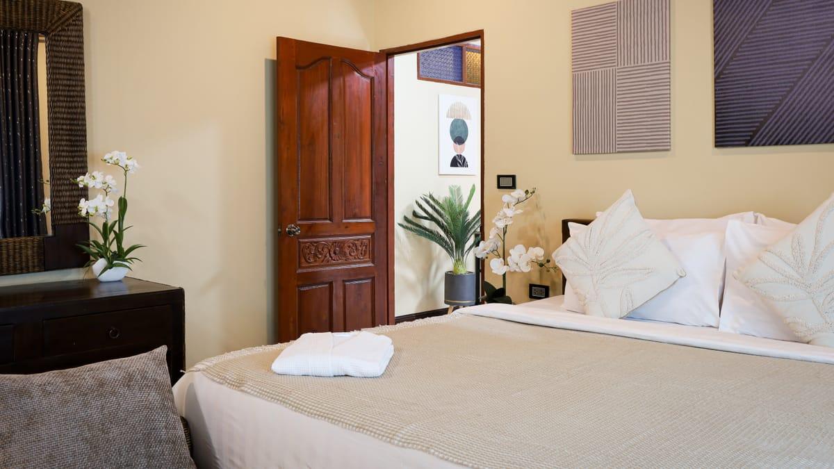 A bedroom with a double bed and folded towels at Jintara Rehab in Chiang Mai