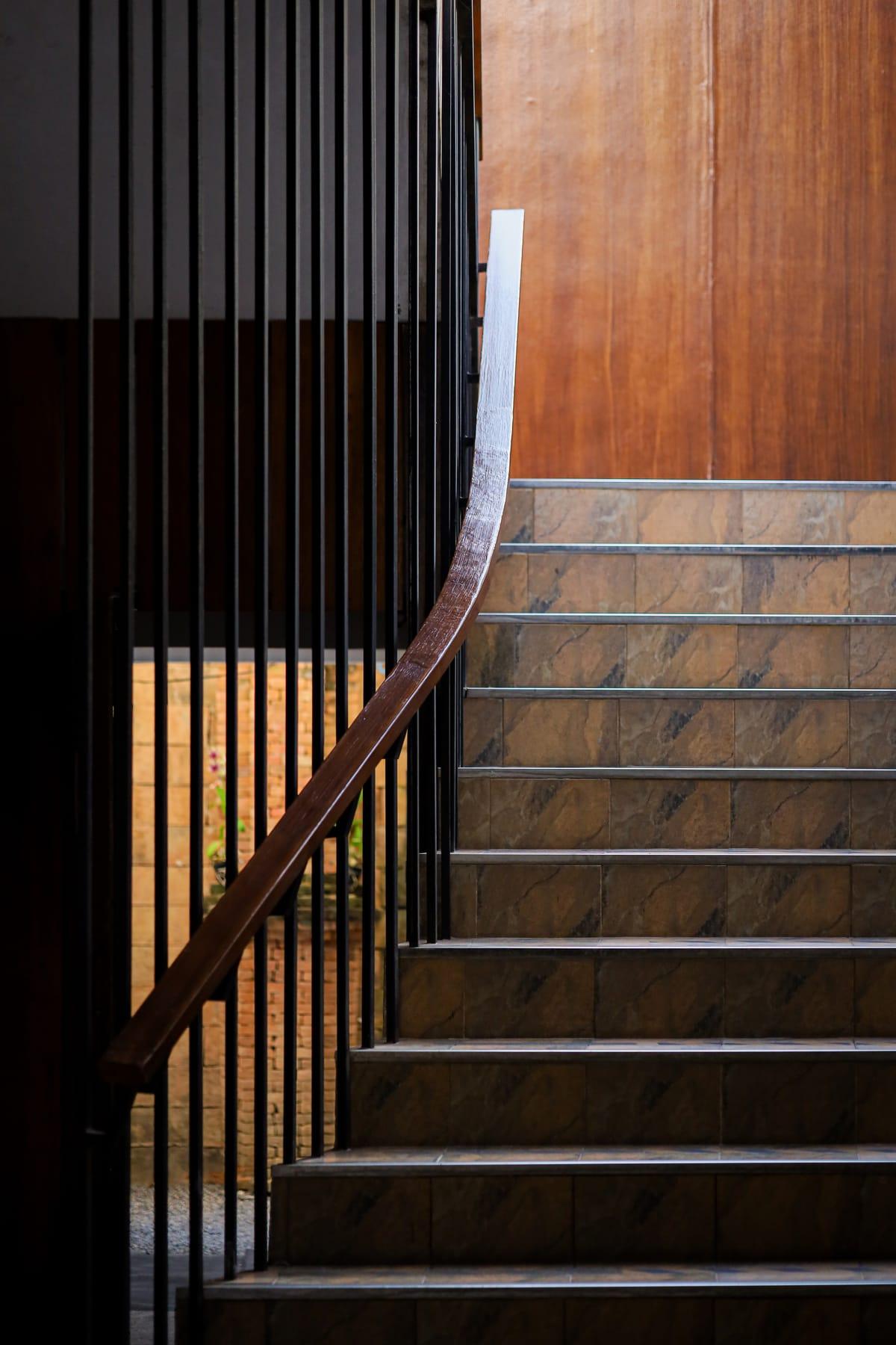 A wooden staircase inside a building at Jintara Rehab in Chiang Mai
