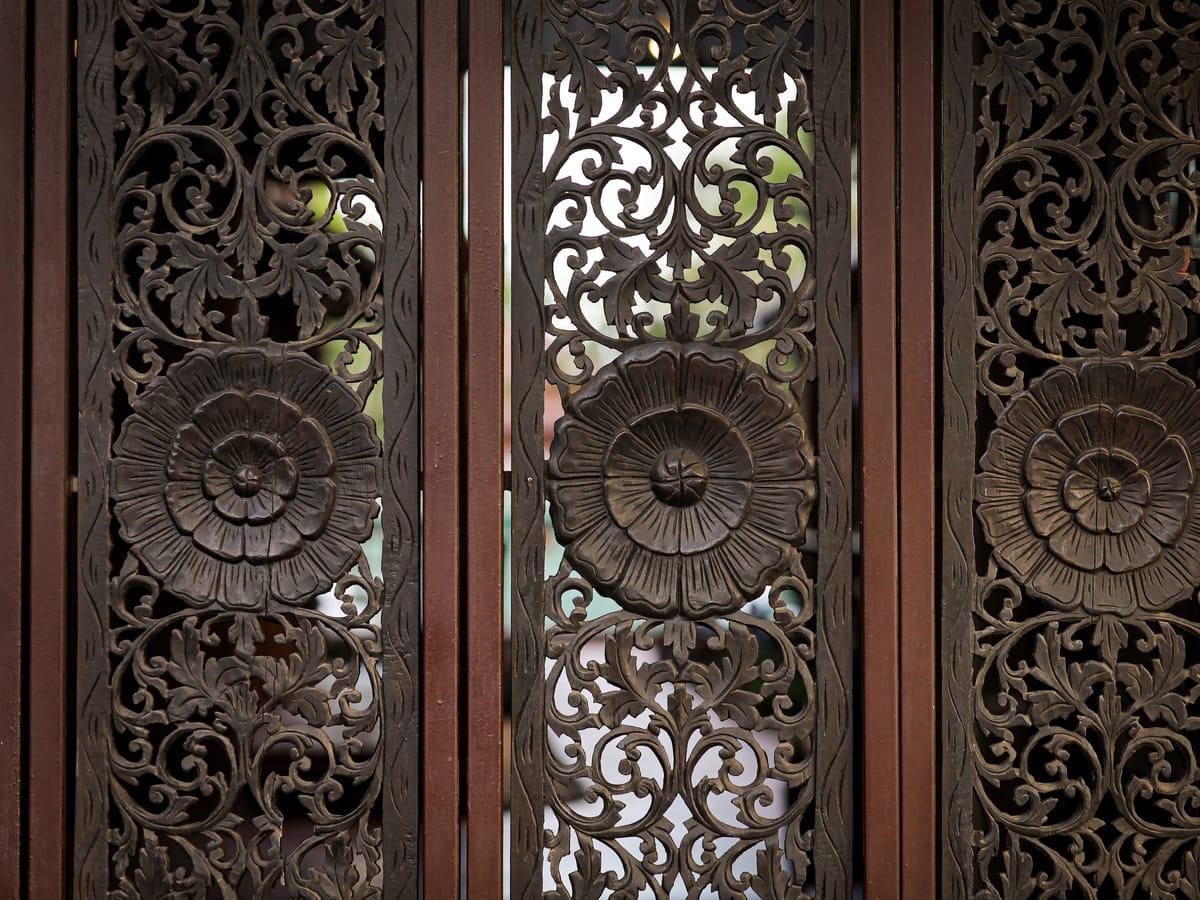 Carved teak lotus panels at Jintara Rehab in Chiang Mai