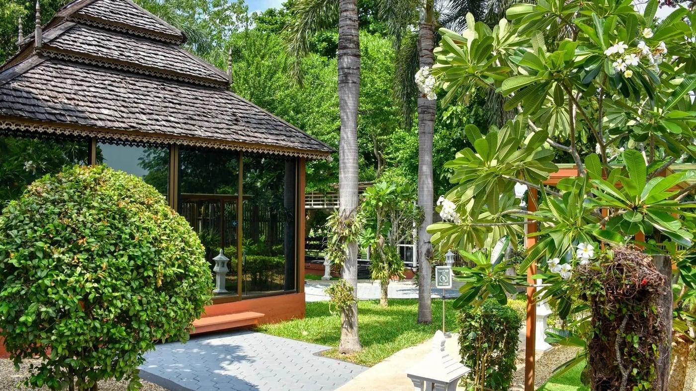 The timber garden pavilion and planted path in the grounds at Jintara Rehab in Chiang Mai, Thailand