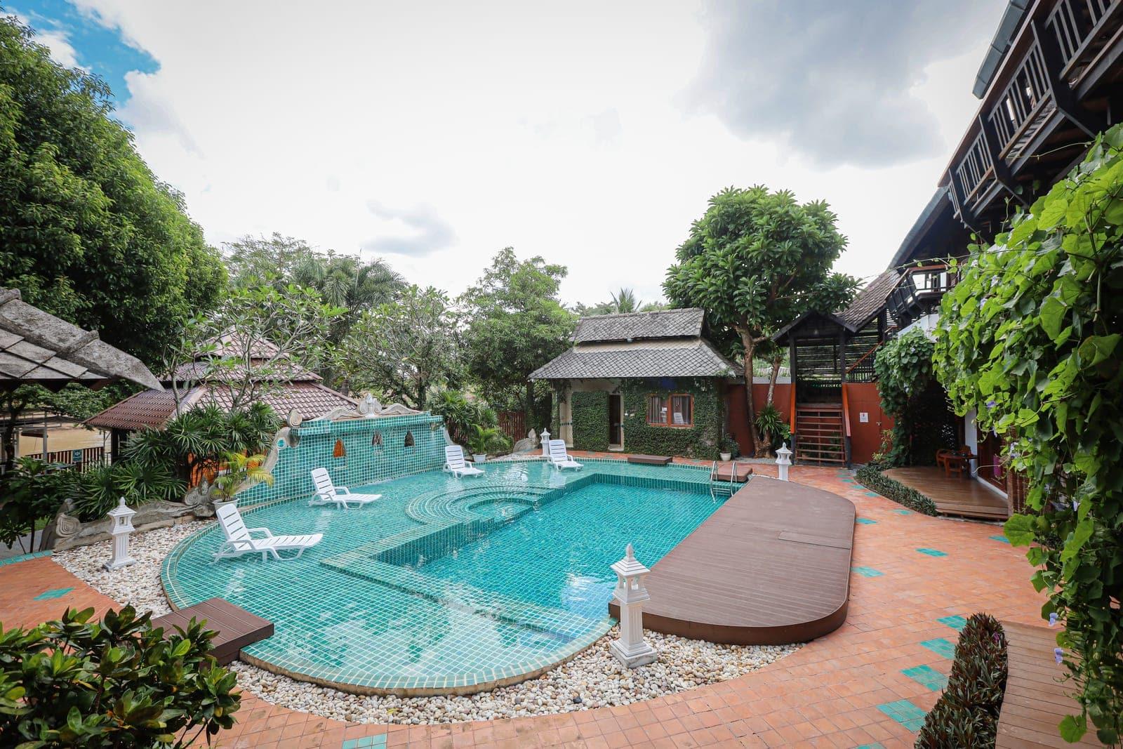 Teal pool and Lanna-style buildings at Jintara Rehab Chiang Mai Thailand xylazine addiction treatment